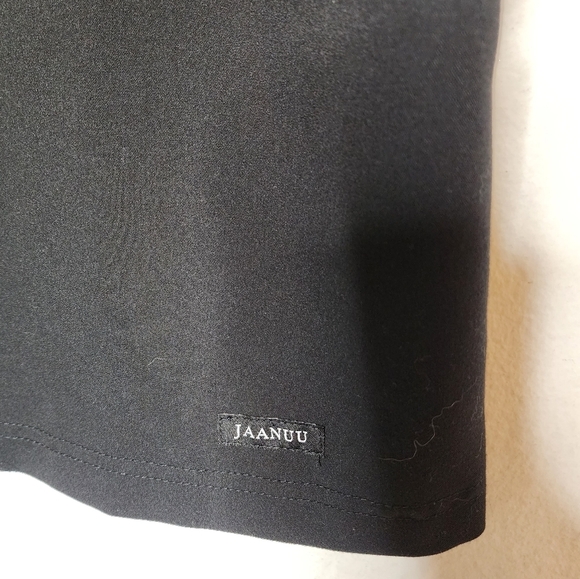 Jaanuu black scrub top. 1 zip chest pocket.  Short sleeve v-neck. Women's size L - Picture 12 of 14